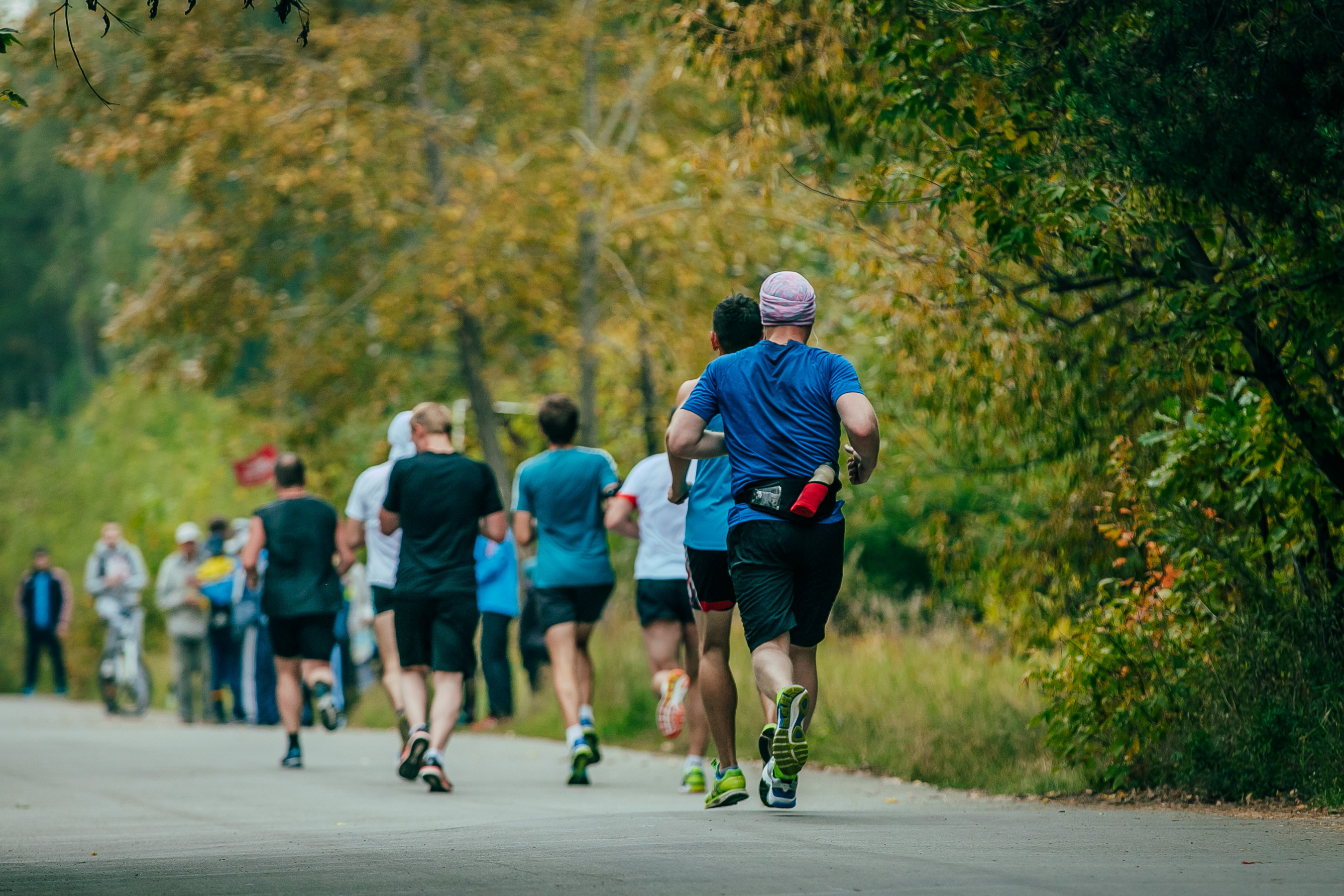 Group of middle aged people running down the street